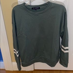 Green sweatshirt with stripped arm detail.